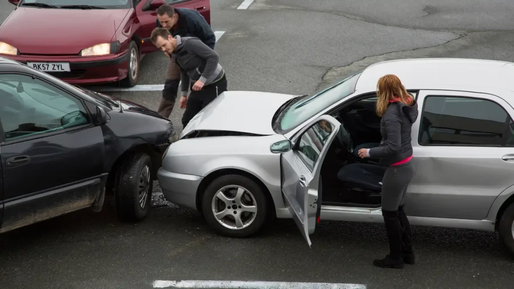 People inspecting a car crash